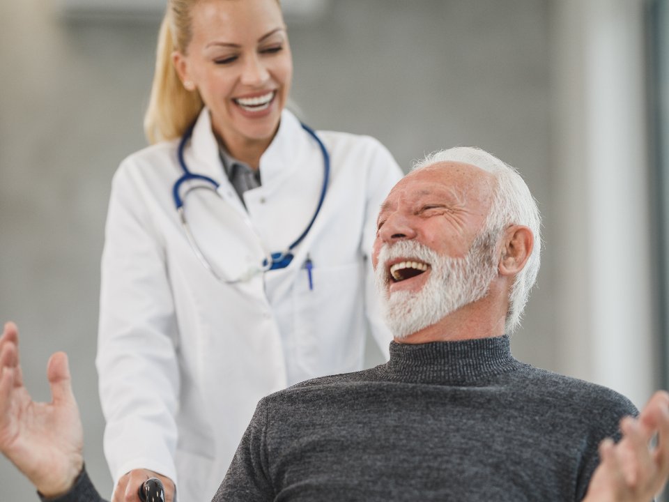 Support worker laughing with a participant