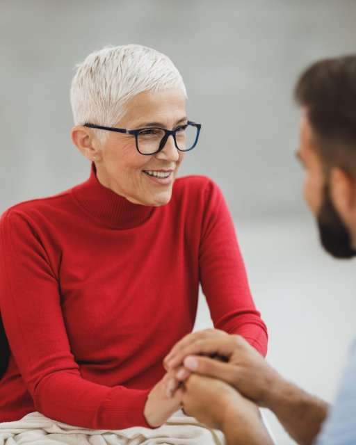 Support worker and participant talking together at home